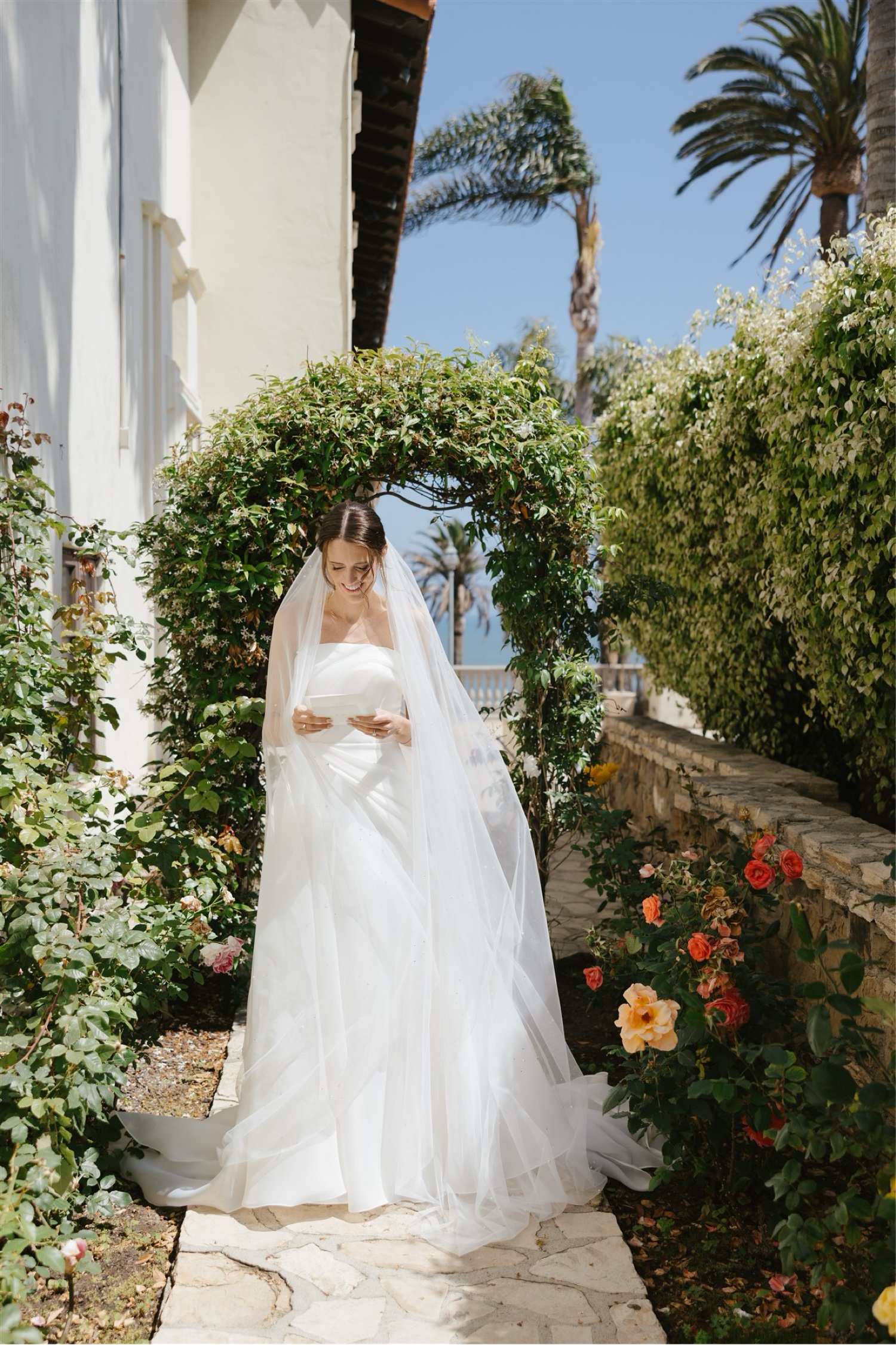 bride reading letter on wedding day at Bel-Air Bay Club California