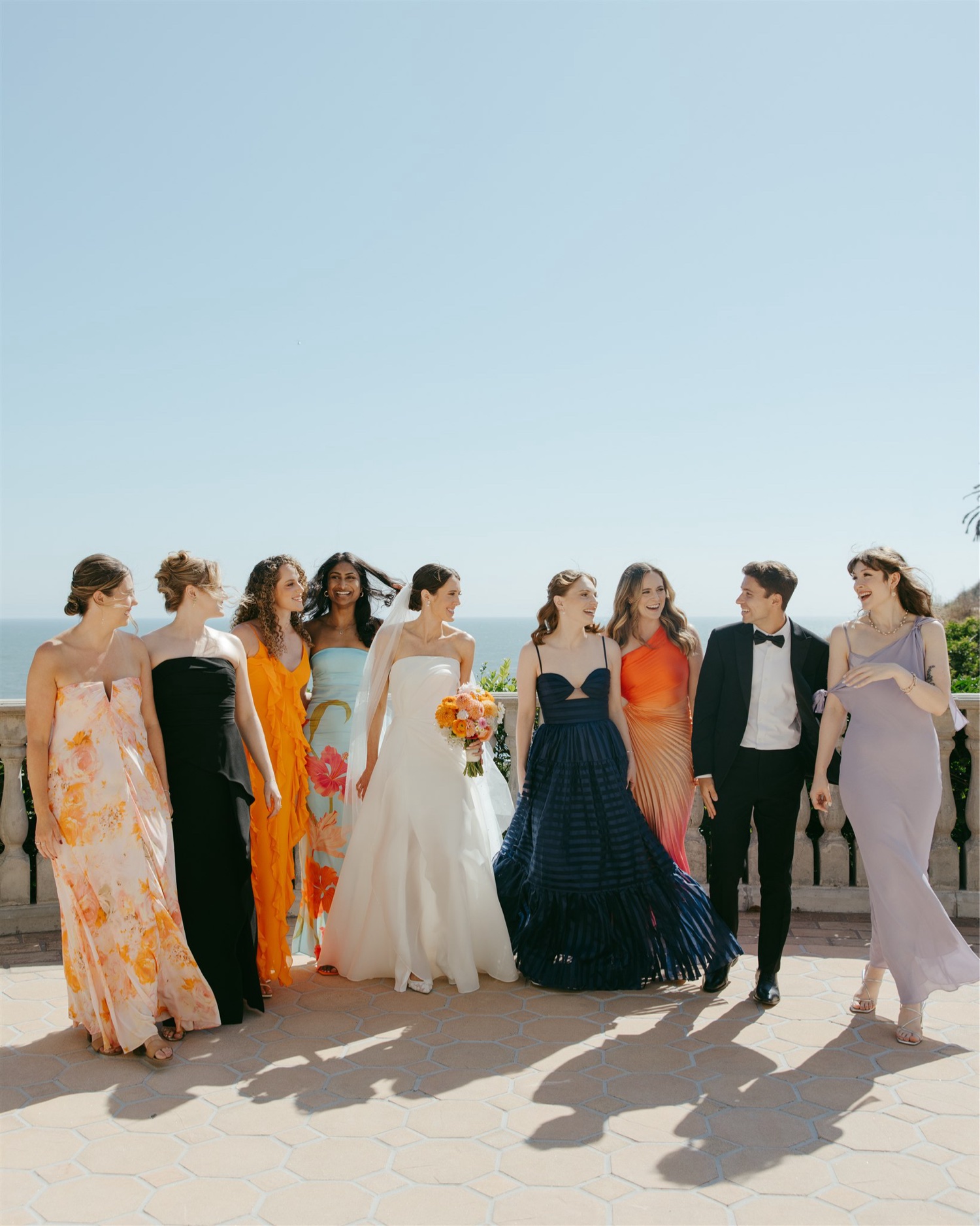 wedding party with mismatched dresses for beach wedding